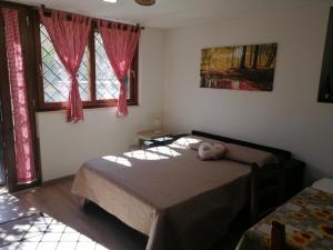 a bedroom with a bed with a stuffed animal on it at La Casa del Borgo-intero appartamento in Latina