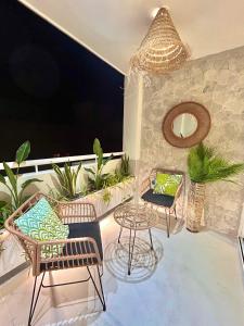 a patio with chairs and a table on a balcony at The Terrace Canalejas in Alicante