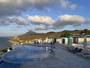 a swimming pool with a view of the ocean at The Rocas Hotel in Kyrenia