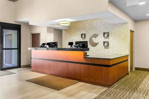 a hotel lobby with a cash counter with a cbucks sign at Comfort Suites Grayslake near Libertyville North in Grayslake +33 photos