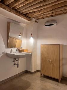 a bathroom with a sink and a cabinet and a mirror at Apartamentos GARABATA in Villanueva de la Vera +122 photos