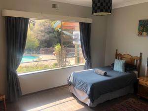 a bedroom with a bed and a large window at Schilbach House in Parys +23 photos