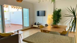 a living room with a table and a dining room at Mojacar 1ª linea playa vacaciones in Mojácar
