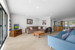 WaikawaUnit 8 Waterfront Holiday Home的带沙发和桌子的客厅