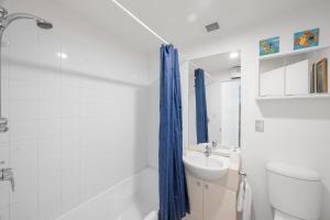 WaikawaUnit 8 Waterfront Holiday Home的白色的浴室设有水槽、卫生间和淋浴。