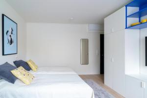 a bedroom with a white bed with pillows on it at Northern Lights City Cabin in Rovaniemi
