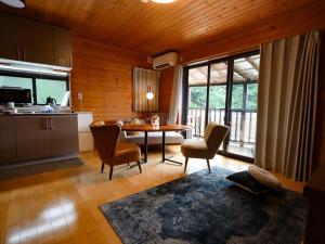 a kitchen and dining room with a table and chairs at Atami Costa resort with Onsen in Nakano