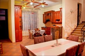 a kitchen with a dining room table and chairs at Ivy Boutique Hotel in Yerevan