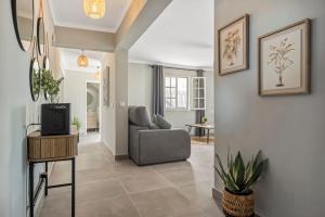 a living room with a couch and a chair at Villa Pedreiro in Funchal