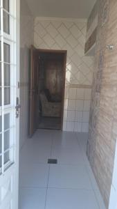 an empty bathroom with a room with a couch at Casa Margarida in Brasília +9 photos