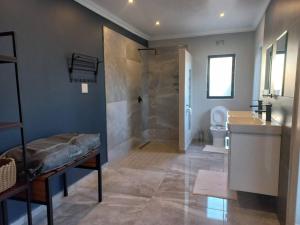 a bathroom with a shower and a toilet and a sink at Comfortable and luxurious stay in Gweru +29 photos