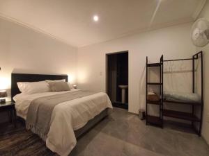 a bedroom with a bed and a shelf in it at Comfortable and luxurious stay in Gweru
