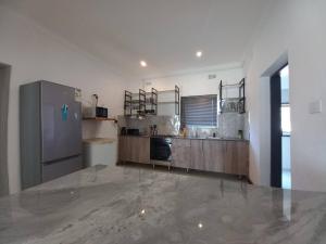 a kitchen with a stainless steel refrigerator in a room at Comfortable and luxurious stay in Gweru