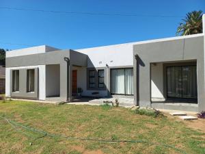 a house with a lawn in front of it at Comfortable and luxurious stay in Gweru