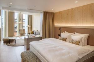 a bedroom with a large bed and a living room at Solo Sokos Hotel Pier 4 in Helsinki +38 photos