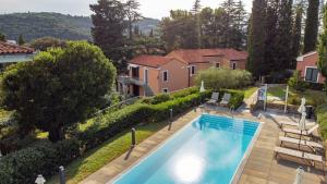 an overhead view of a swimming pool in front of a house at Hotel Laguna Deluxe - Terme Krka in Strunjan