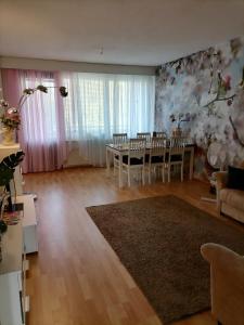 a living room with a table and a dining room at Asunto Kitee in Kitee