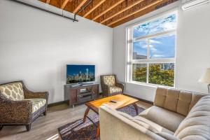 a living room with a couch and a tv at Tracyton Condo #202 in Bremerton