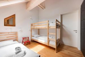 a bedroom with two bunk beds and a ladder at Apartment Pr Cirklu, Kranjska Gora in Kranjska Gora