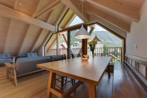 a living room with a table and a couch at Apartment Pr Cirklu, Kranjska Gora in Kranjska Gora
