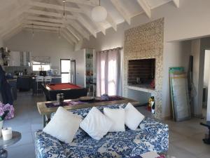 a living room with a couch and a pool table at Sassa in St Helena Bay