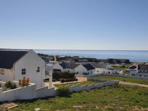 a view of a neighborhood with houses and the ocean at Sassa in St Helena Bay