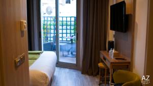 a hotel room with a bed and a door to a balcony at AZ hôtel des arts in Rabat