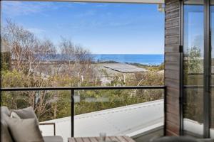 a view of the ocean from the balcony of a house at Torquay Point White-Water Retreat in Torquay