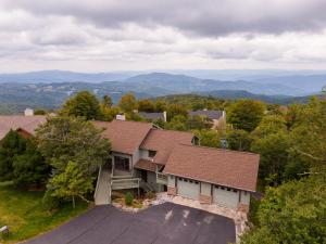 an aerial view of a house with a roof at Hill Station in Beech Mountain
