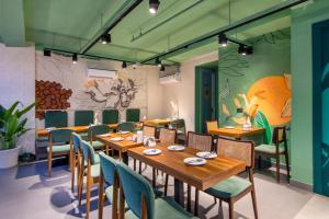 a restaurant with a wooden table and chairs at The Orion Elite - Green Park in New Delhi