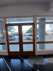 an entrance to an n exit with glass doors at Departamento COSTAMAR in Miramar +1 photo