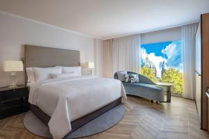 a bedroom with a large bed and a large window at The Westin Grand Berlin in Berlin
