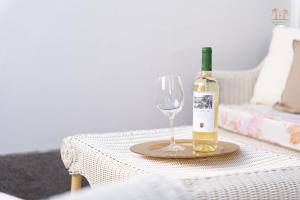 a bottle of wine sitting on a table with a wine glass at Linda House in Maspalomas