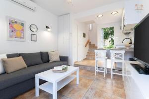 a living room with a couch and a table at Linda House in Maspalomas