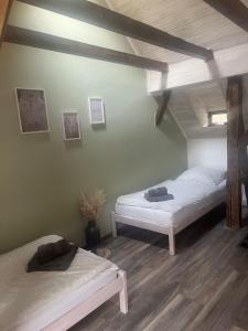 two beds sitting in a room with a ceiling at Heimerlmühle in Neunburg vorm Wald +13 photos
