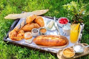 a tray of bread and croissants on a table at Bella Vista Hôtel, Suites & Maisons in Porticcio