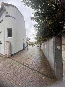 a brick sidewalk next to a white building at Hotel Montan in Duisburg