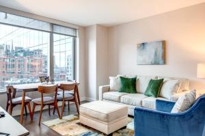 a living room with a couch and a table at Luxury Apt in the Heart of Seaport in Boston