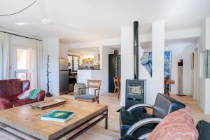 a living room with a table and a fireplace at Pinos y Mar in Gran Alacant
