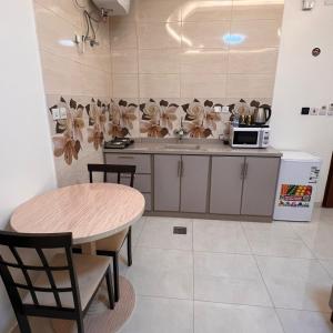 a kitchen with a table and a microwave in it at شقق سويت ستار للشقق المخدومة in Tabuk +23 photos