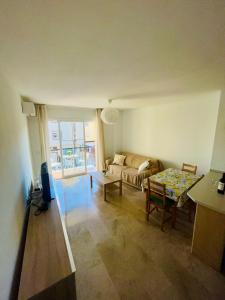 a living room with a couch and a table at Apartamento Tomillo in Rincón de la Victoria