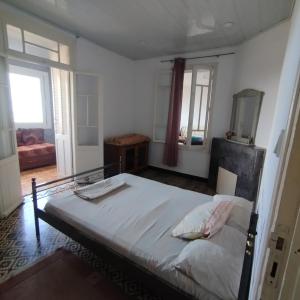 a bedroom with a large bed and a mirror at Alger avec vue imprenable sur la Baie d'Alger Piscine Balcon Terrasse in El Mouradia +10 photos