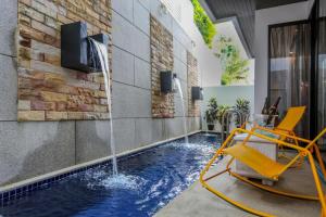 a pool with a water feature in a house at Naiharn Pool Villa Number 5 in Rawai Beach