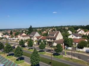 arial view of a suburb with houses and a street at Chez karine 4 in Arpajon