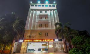 a large building with a clock tower at night at Hotel Orion Crystal in Kolkata