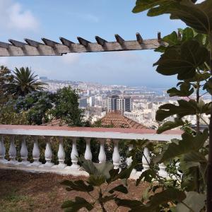 a view of a city from a white fence at Alger avec vue imprenable sur la Baie d'Alger Piscine Balcon Terrasse in El Mouradia