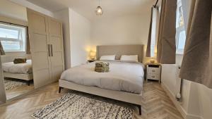 a bedroom with two beds and a rug at Camden Market Properties in London