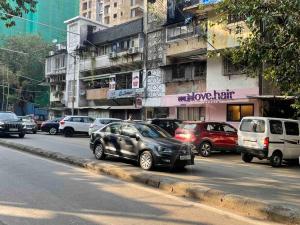 a group of cars parked on a city street at 1BHK CASA BELLA Off Linking rd Ground floor in Mumbai