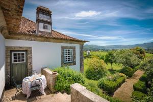 a table sitting on the outside of a house at Paço de Lanheses - Turismo de Habitação in Lanheses +16 photos