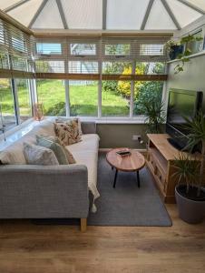 a living room with a couch and a table at Modern 3B Eastbourne Retreat: Tranquil & Cozy Stay in Eastbourne